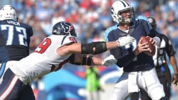Oct 26, 2014; Nashville, TN, USA; Tennessee Titans quarterback Zach Mettenberger (7) is sacked by Houston Texans defensive end J.J. Watt (99) during the second half at LP Field. The Texans beat the Titans 30-16. Mandatory Credit: Don McPeak-USA TODAY Sports