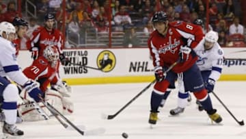 Apr 13, 2014; Washington, DC, USA; Washington Capitals right wing Alex Ovechkin (8) clears the puck from in front of Capitals goalie Braden Holtby (70) as Tampa Bay Lightning center Alex Killorn (17) chases in the first period at Verizon Center. Mandatory Credit: Geoff Burke-USA TODAY Sports