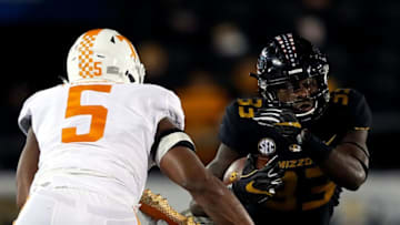 COLUMBIA, MO - NOVEMBER 11: Running back Larry Rountree III #33 of the Missouri Tigers carries the ball as defensive back Nigel Warrior #18 and defensive lineman Kyle Phillips #5 of the Tennessee Volunteers defend during the game at Faurot Field/Memorial Stadium on November 11, 2017 in Columbia, Missouri. (Photo by Jamie Squire/Getty Images)