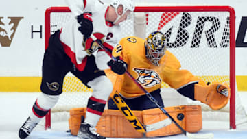 Dec 10, 2022; Nashville, Tennessee, USA; Nashville Predators goaltender Juuse Saros (74) makes a save on a shot by Ottawa Senators left wing Brady Tkachuk (7) during the first period at Bridgestone Arena. Mandatory Credit: Christopher Hanewinckel-USA TODAY Sports