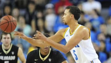 February 13, 2014; Los Angeles, CA, USA; UCLA Bruins guard/forward Kyle Anderson (5) controls the ball against Colorado Buffaloes forward Xavier Johnson (2) during the first half at Pauley Pavilion. Mandatory Credit: Gary A. Vasquez-USA TODAY Sports