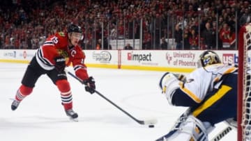 Dec 29, 2014; Chicago, IL, USA; Chicago Blackhawks center Jonathan Toews (19) scores a goal against Nashville Predators goalie Pekka Rinne (35) during the shootout at the United Center. The Chicago Blackhawks defeat the Nashville Predators 5-4 in a shootout. Mandatory Credit: Mike DiNovo-USA TODAY Sports