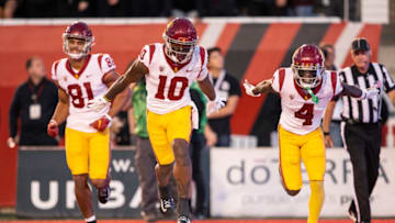 SALT LAKE CITY UT- OCTOBER 15: Kyron Hudson #10 of the USC Trojans celebrates scoring a touchdown with teammates Kyle Ford #81 and Mario Williams #4 during the first half of their game against the Utah Utes October 15, 2022 Rice-Eccles Stadium in Salt Lake City Utah. (Photo by Chris Gardner/ Getty Images)