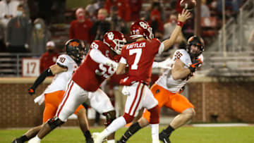 Nov 21, 2020; Norman, Oklahoma, USA; Oklahoma Sooners quarterback Spencer Rattler (7) throws a touchdown pass during the second half against the Oklahoma State Cowboys at Gaylord Family-Oklahoma Memorial Stadium. Mandatory Credit: Kevin Jairaj-USA TODAY Sports