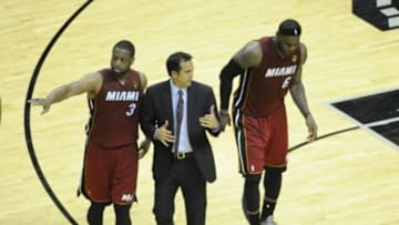Jun 5, 2014; San Antonio, TX, USA; Miami Heat forward LeBron James (6) reacts after getting injured in the fourth quarter as he is helped by guard Dwyane Wade (3) and head coach Erik Spoelstra against the San Antonio Spurs in game one of the 2014 NBA Finals at AT&T Center. The Spurs beat the Heat 110-95. Mandatory Credit: Brendan Maloney-USA TODAY Sports