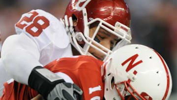 ARLINGTON, TX - DECEMBER 4: Linebacker Travis Lewis #28 of the Oklahoma Sooners wraps up I-back Roy Helu, Jr. #10 of the Nebraska Cornhuskers, December 4, 2010 at Cowboys Stadium in Arlington, Texas. (Photo by Jackson Laizure/Getty Images)
