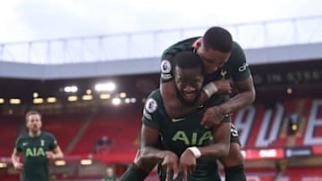 Tottenham Hotspur's French midfielder Tanguy Ndombele (front) celebrates scoring his team's third goal with Tottenham Hotspur's Dutch midfielder Steven Bergwijn (top) during the English Premier League football match between Sheffield United and Tottenham Hotspur at Bramall Lane in Sheffield, northern England on January 17, 2021. (Photo by Laurence Griffiths / POOL / AFP) / RESTRICTED TO EDITORIAL USE. No use with unauthorized audio, video, data, fixture lists, club/league logos or 'live' services. Online in-match use limited to 120 images. An additional 40 images may be used in extra time. No video emulation. Social media in-match use limited to 120 images. An additional 40 images may be used in extra time. No use in betting publications, games or single club/league/player publications. / (Photo by LAURENCE GRIFFITHS/POOL/AFP via Getty Images)