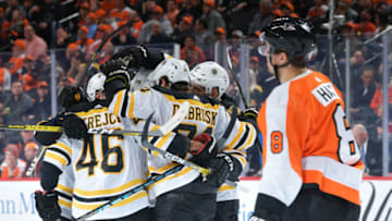 PHILADELPHIA, PA - MARCH 10: Matt Grzelcyk #48, David Krejci #46, David Pastrnak #88,Torey Krug #47 and Patrice Bergeron #37 of the Boston Bruins celebrate a goal as Robert Hagg #8 of the Philadelphia Flyers skates by in the second period at Wells Fargo Center on March 10, 2020 in Philadelphia, Pennsylvania. (Photo by Drew Hallowell/Getty Images)