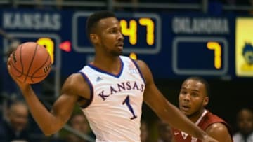 Jan 4, 2016; Lawrence, KS, USA; Kansas Jayhawks guard Wayne Selden Jr. (1) passes against Oklahoma Sooners guard Jordan Woodard (10) in the first half at Allen Fieldhouse. Mandatory Credit: John Rieger-USA TODAY Sports