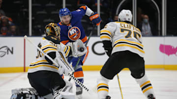 Jun 3, 2021; Uniondale, New York, USA; Boston Bruins goalie Tuukka Rask (40) makes a save in front of New York Islanders center Mathew Barzal (13) during the overtime period of game three of the second round of the 2021 Stanley Cup Playoffs at Nassau Veterans Memorial Coliseum. Mandatory Credit: Brad Penner-USA TODAY Sports