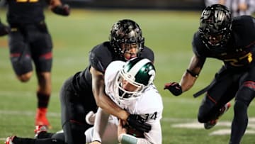 Oct 22, 2016; College Park, MD, USA; Michigan State Spartans quarterback Brian Lewerke (14) tackled after gaining yards on a run against the Maryland Terrapins at Byrd Stadium. Mandatory Credit: Mitch Stringer-USA TODAY Sports
