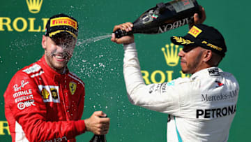 BUDAPEST, HUNGARY - JULY 29: Race winner Lewis Hamilton of Great Britain and Mercedes GP and second place Sebastian Vettel of Germany and Ferrari celebrate on the podium during the Formula One Grand Prix of Hungary at Hungaroring on July 29, 2018 in Budapest, Hungary. (Photo by Charles Coates/Getty Images)
