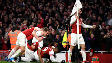 LONDON, ENGLAND - DECEMBER 02: Alexandre Lacazette of Arsenal celebrates with teammates after scoring his team's third goal during the Premier League match between Arsenal FC and Tottenham Hotspur at Emirates Stadium on December 1, 2018 in London, United Kingdom. (Photo by Shaun Botterill/Getty Images)