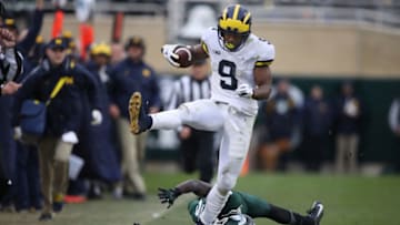 EAST LANSING, MI - OCTOBER 20: Donovan Peoples-Jones #9 of the Michigan Wolverines catches a second half touchdown and avoids the tackle of Tre Person #24 the Michigan State Spartans at Spartan Stadium on October 20, 2018 in East Lansing, Michigan. (Photo by Gregory Shamus/Getty Images)