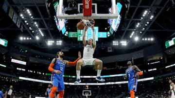 D.J. Wilson #5 of the Milwaukee Bucks dunks the ball past Steven Adams #12 of the Oklahoma City Thunder in the third quarter at the Fiserv Forum on April 10, 2019 in Milwaukee, Wisconsin. NOTE TO USER: User expressly acknowledges and agrees that, by downloading and or using this photograph, User is consenting to the terms and conditions of the Getty Images License Agreement. (Photo by Dylan Buell/Getty Images)