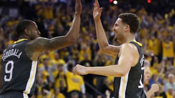 OAKLAND, CA - MAY 01: Klay Thompson #11 congratulates Andre Iguodala #9 of the Golden State Warriors after he made a basket and was fouled by the New Orleans Pelicans during Game Two of the Western Conference Semifinals during the 2018 NBA Playoffs at ORACLE Arena on May 1, 2018 in Oakland, California. NOTE TO USER: User expressly acknowledges and agrees that, by downloading and or using this photograph, User is consenting to the terms and conditions of the Getty Images License Agreement. (Photo by Ezra Shaw/Getty Images)