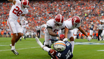 AUBURN, AL - NOVEMBER 25: Darius Slayton #81 of the Auburn Tigers is tackled by Minkah Fitzpatrick #29, Hootie Jones #6, and Anthony Averett #28 of the Alabama Crimson Tide after catching a pass during the first quarter of the game at Jordan Hare Stadium on November 25, 2017 in Auburn, Alabama. (Photo by Kevin C. Cox/Getty Images)