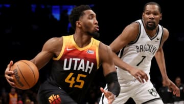 Mar 21, 2022; Brooklyn, New York, USA; Utah Jazz guard Donovan Mitchell (45) drives to the basket against Brooklyn Nets forward Kevin Durant (7) during the fourth quarter at Barclays Center. Mandatory Credit: Brad Penner-USA TODAY Sports