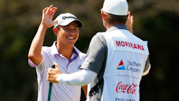 ATLANTA, GEORGIA - SEPTEMBER 06: Collin Morikawa of the United States celebrates with his caddie after holing out from a bunker on the first hole during the third round of the TOUR Championship at East Lake Golf Club on September 06, 2020 in Atlanta, Georgia. (Photo by Kevin C. Cox/Getty Images)