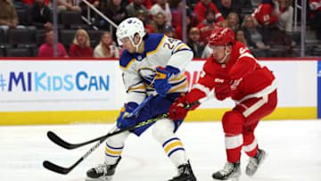 DETROIT, MICHIGAN - NOVEMBER 30: Dylan Cozens #24 of the Buffalo Sabres gets past Lucas Raymond #23 of the Detroit Red Wings to score a first period goal at Little Caesars Arena on November 30, 2022 in Detroit, Michigan. (Photo by Gregory Shamus/Getty Images)
