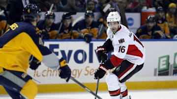 Feb 10, 2015; Buffalo, NY, USA; Ottawa Senators left wing Clarke MacArthur (16) heads up ice with the puck as Buffalo Sabres defenseman Josh Gorges (4) defends during the first period at First Niagara Center. Mandatory Credit: Kevin Hoffman-USA TODAY Sports