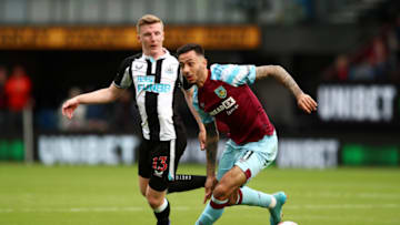 BURNLEY, ENGLAND - MAY 22: Dwight McNeil of Burnley on the ball whilst under pressure from Matt Targett of Newcastle United during the Premier League match between Burnley and Newcastle United at Turf Moor on May 22, 2022 in Burnley, England. (Photo by Jan Kruger/Getty Images)