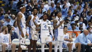 CHAPEL HILL, NORTH CAROLINA - DECEMBER 01: Leaky Black #1 and R.J. Davis #4 of the North Carolina Tar Heels jokes with the student section during the final minute of their game against the Michigan Wolverines at the Dean E. Smith Center on December 01, 2021 in Chapel Hill, North Carolina. The Tar Heels won 72-51. (Photo by Grant Halverson/Getty Images)