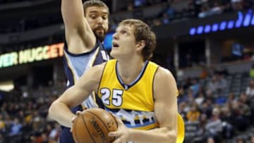 Jan 3, 2015; Denver, CO, USA; Denver Nuggets center Timofey Mozgov (25) looks to shoot against Memphis Grizzlies center Marc Gasol (33) during the first half at Pepsi Center. Mandatory Credit: Chris Humphreys-USA TODAY Sports