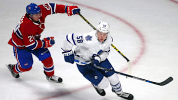 Sep 22, 2015; Montreal, Quebec, CAN; Toronto Maple Leafs defenseman Andrew Nielsen (58) plays the puck against Montreal Canadiens center Christian Thomas (20) during the second period at Bell Centre. Mandatory Credit: Jean-Yves Ahern-USA TODAY Sports