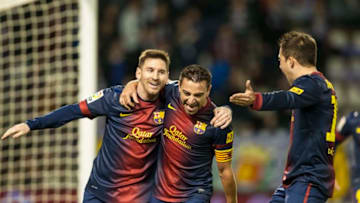 Xavi Hernandez (C) of FC Barcelona celebrates with his teammate Lionel Messi (Photo by Victor Fraile/Getty Images)