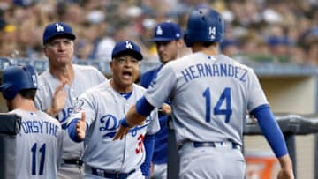 MILWAUKEE, WI - JULY 22: Manager Dave Roberts of the Los Angeles Dodgers congratulates Enrique Hernandez #14 after Hernandez scored a run in the second inning against the Milwaukee Brewers at Miller Park on July 22, 2018 in Milwaukee, Wisconsin. (Photo by Dylan Buell/Getty Images)