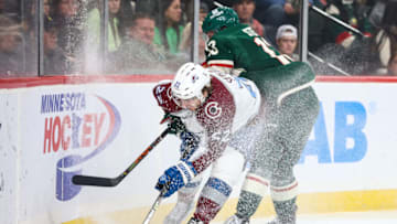Oct 17, 2022; Saint Paul, Minnesota, USA; Colorado Avalanche center Lukas Sedlak (22) and Minnesota Wild center Sam Steel (13) battle for the puck during the first period at Xcel Energy Center. Mandatory Credit: Matt Krohn-USA TODAY Sports