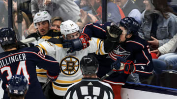 Apr 4, 2022; Columbus, Ohio, USA; Boston Bruins left wing Jake DeBrusk (left) and Columbus Blue Jackets defenseman Andrew Peeke (right) scrum during a stop in play in the second period at Nationwide Arena. Mandatory Credit: Aaron Doster-USA TODAY Sports