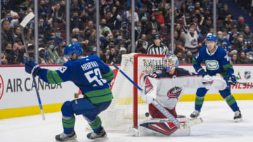 Dec 14, 2021; Vancouver, British Columbia, CAN; Vancouver Canucks forward Bo Horvat (53) scores the game winning goal on Columbus Blue Jackets goalie Elvis Merzlikins (90) in the third period at Rogers Arena. Vancouver Won 4-3. Mandatory Credit: Bob Frid-USA TODAY Sports