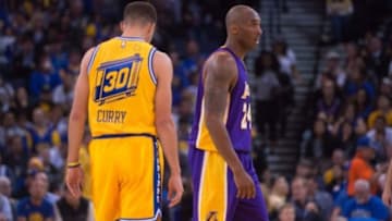 November 24, 2015; Oakland, CA, USA; Los Angeles Lakers forward Kobe Bryant (24) walks past Golden State Warriors guard Stephen Curry (30) during the second quarter at Oracle Arena. The Warriors defeated the Lakers 111-77. Mandatory Credit: Kyle Terada-USA TODAY Sports