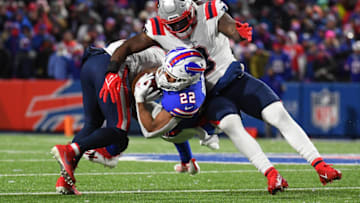 Dec 6, 2021; Orchard Park, New York, USA; New England Patriots cornerback Myles Bryant (left) and middle linebacker Ja'Whaun Bentley (right) tackle Buffalo Bills running back Matt Breida (22) during the first half at Highmark Stadium. Mandatory Credit: Rich Barnes-USA TODAY Sports