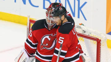 Nov 6, 2015; Newark, NJ, USA; New Jersey Devils defenseman Adam Larsson (5) congratulates goalie Cory Schneider (35) after their 4-2 win over the Chicago Blackhawks at Prudential Center. Mandatory Credit: Ed Mulholland-USA TODAY Sports