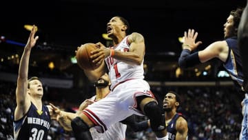 Oct 7, 2013; St. Louis, MO, USA; Chicago Bulls point guard Derrick Rose (1) goes for a lay up during the first quarter against Memphis Grizzlies power forward Jon Leuer (30) at Scottrade Center. Mandatory Credit: Jeff Curry-USA TODAY Sports