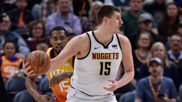 SALT LAKE CITY, UT - APRIL 09: Nikola Jokic #15 of the Denver Nuggets looks to pass in front of Derrick Favors #15 of the Utah Jazz in the first half of a NBA game at Vivint Smart Home Arena on April 09, 2019 in Salt Lake City, Utah. NOTE TO USER: User expressly acknowledges and agrees that, by downloading and or using this photograph, User is consenting to the terms and conditions of the Getty Images License Agreement. (Photo by Gene Sweeney Jr./Getty Images)