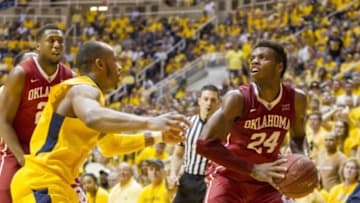Feb 20, 2016; Morgantown, WV, USA; Oklahoma Sooners guard Buddy Hield (24) prepares to shoot the ball as West Virginia Mountaineers guard Jevon Carter (2) defends during the first half at the WVU Coliseum. Mandatory Credit: Ben Queen-USA TODAY Sports