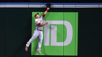 Los Angeles Angels center fielder Mike Trout (27) leaps but can't reach a home run hit by Toronto Blue Jays third baseman Josh Donaldson (not pictured) in the first inning at Rogers Centre. Mandatory Credit: Dan Hamilton-USA TODAY Sports