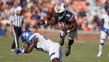Auburn footballSep 25, 2021; Auburn, Alabama, USA; Auburn Tigers receiver Kobe Hudson (5) gets airborne over Georgia State Panthers safety Chris Moore (28) during the second quarter at Jordan-Hare Stadium. Mandatory Credit: John Reed-USA TODAY Sports