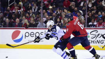 WASHINGTON, DC - MARCH 12: Patrik Laine #29 of the Winnipeg Jets and Alex Ovechkin #8 of the Washington Capitals battle for the puck in the second period at Capital One Arena on March 12, 2018 in Washington, DC. (Photo by Patrick McDermott/NHLI via Getty Images)