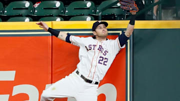 HOUSTON, TEXAS - MAY 09: Josh Reddick #22 of the Houston Astros makes a leaping catch at the wall on deep fly ball by Hunter Pence #24 of the Texas Rangers in the ninth inning at Minute Maid Park on May 09, 2019 in Houston, Texas. (Photo by Bob Levey/Getty Images)