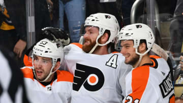 PITTSBURGH, PA - MARCH 17: Sean Couturier #14 of the Philadelphia Flyers celebrates his overtime goal with Shayne Gostisbehere #53 and Scott Laughton #21 against the Pittsburgh Penguins at PPG Paints Arena on March 17, 2019 in Pittsburgh, Pennsylvania. (Photo by Joe Sargent/NHLI via Getty Images)
