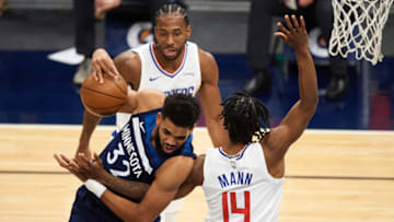 MINNEAPOLIS, MINNESOTA - FEBRUARY 10: Terance Mann #14 of the Los Angeles Clippers fouls Karl-Anthony Towns #32 of the Minnesota Timberwolves during the second quarter of the game at Target Center on February 10, 2021 in Minneapolis, Minnesota. NOTE TO USER: User expressly acknowledges and agrees that, by downloading and or using this Photograph, user is consenting to the terms and conditions of the Getty Images License Agreement (Photo by Hannah Foslien/Getty Images)