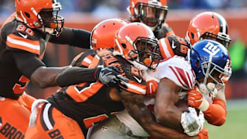 Nov 27, 2016; Cleveland, OH, USA; New York Giants running back Rashad Jennings (23) is tackled by the Cleveland Browns defense led by cornerback Briean Boddy-Calhoun (20) during the second half at FirstEnergy Stadium. The Giants won 27-13. Mandatory Credit: Ken Blaze-USA TODAY Sports
