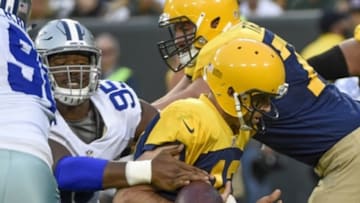 Oct 16, 2016; Green Bay, WI, USA; Dallas Cowboys defensive lineman David Irving (95) strips the ball from Green Bay Packers quarterback Aaron Rodgers (12) causing a fumble in the fourth quarter at Lambeau Field. Mandatory Credit: Benny Sieu-USA TODAY Sports