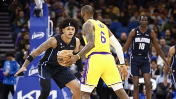 ORLANDO, FLORIDA - DECEMBER 27: LeBron James #6 of the Los Angeles Lakers dribbles the ball as Paolo Banchero #5 of the Orlando Magic defends during the first quarter at Amway Center on December 27, 2022 in Orlando, Florida. NOTE TO USER: User expressly acknowledges and agrees that, by downloading and or using this photograph, User is consenting to the terms and conditions of the Getty Images License Agreement. (Photo by Douglas P. DeFelice/Getty Images)