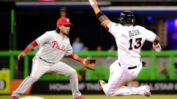 Sep 7, 2016; Miami, FL, USA; Philadelphia Phillies shortstop Freddy Galvis (13) is late on tagging out Miami Marlins right fielder Marcell Ozuna (13) at second base during the sixth inning at Marlins Park. Mandatory Credit: Steve Mitchell-USA TODAY Sports